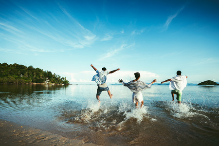 Asian family running of sunset beach and seaの写真素材
