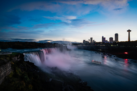 Niagara falls lit at night by colorful lightsの写真素材