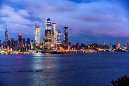 New York City Manhattan skyline panorama at night over Hudson River with refelctions viewed from New Jerseyの写真素材