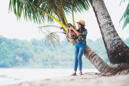 Teenage traveler on the beach with camera, Koh Kut Thailandの写真素材