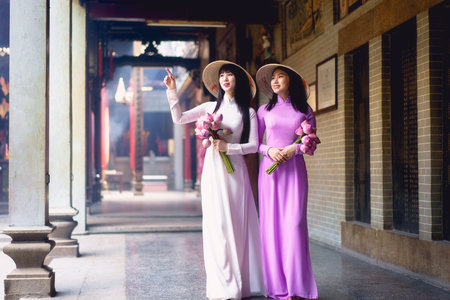 Beautiful vietnamese woman in Ao Dai white-traditional dress of vietnam, Ho Chi Minh city Vietnamの写真素材