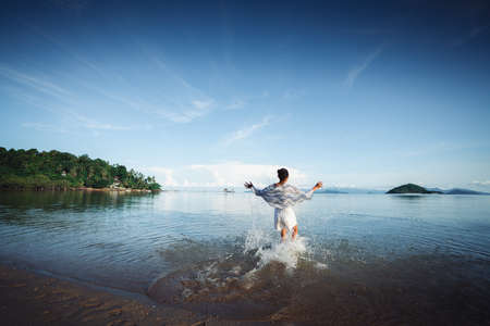 A young girl running on the beach, Trat Thailandの写真素材