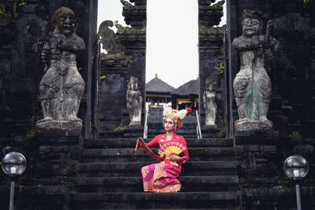 A young Bali female dancer is performing the Ramayana dance in a temple of Bali, in Indonesia.の写真素材