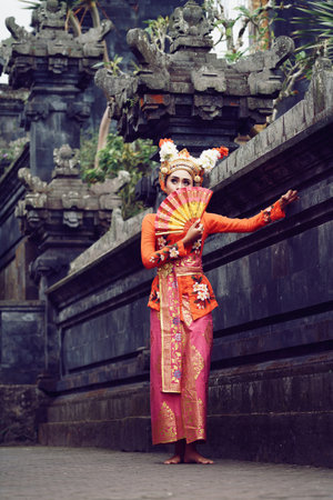 A young Bali female dancer is performing the Ramayana dance in a temple of Bali, in Indonesia.の写真素材