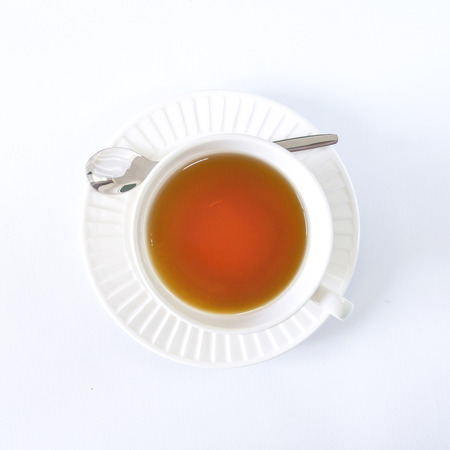 The white cup tea on the white backgroundの写真素材