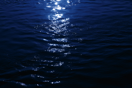 Close up of a moonlight reflected on the sea, romantic nightの写真素材