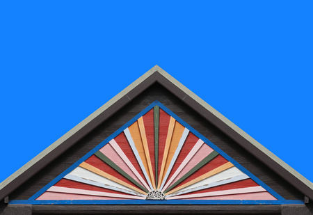 old color wood panels house wall gable roof and clear blue sky