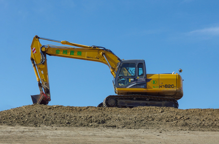 2017 February 19. Tokyo Japan.  Japanese yellow kato regzam HD820V backhoe car stand by for digging the soil of construction place.