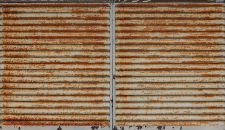horizontal old grunge metal sheet shutter window door texture wall background.の写真素材