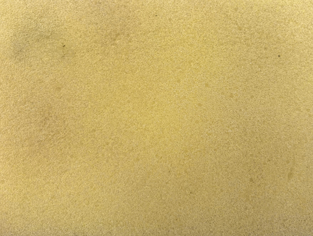 close up on yellow cleaning sponge surface texture background.の写真素材