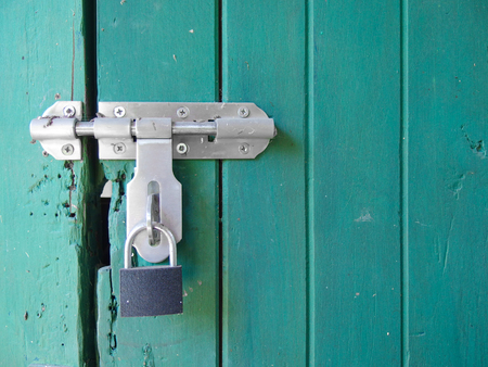 locked key on aged light pastel blue color wood wall background.の写真素材