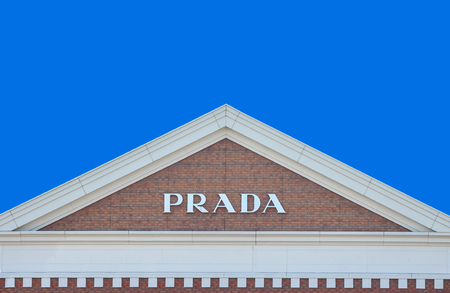 2019 March 26. Tochigi Japan. a modern design of PRADA brand name on gable roof brick wall with blue...