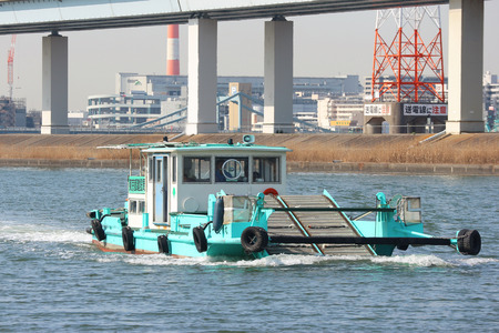 2019 March 28. Tokyo Japan. Japanese trash keeping boat flowing along river surface for cleaning every day.のeditorial素材