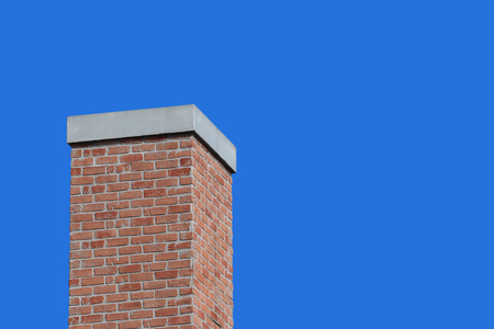 modern retro brick chimney design with blue sky background.の写真素材