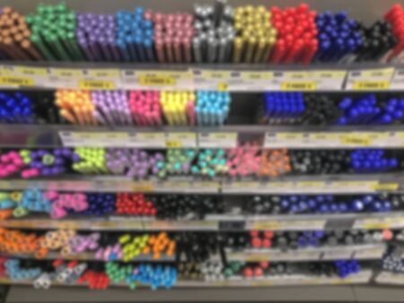 Blurred several color pens stack row in stationary shop store background.の写真素材
