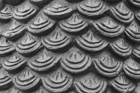 gray cement plaster in fish skin curve pattern texture wall background.