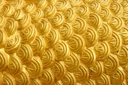 golden cement plaster in fish skin curve pattern texture wall background.
