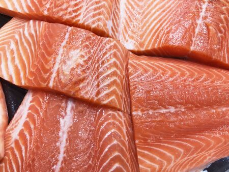 Fresh sliced salmon meat surface texture for cooking.