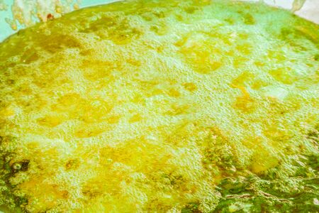 Hot boiling frying oil surface on pan background.の写真素材