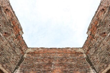 Dirty old weathered Brick building wall with clear sky background.の写真素材