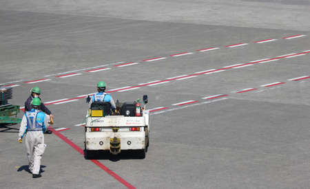 2020 March 04. Chiba JAPAN. Airport ground engineer stuff working on sunny day at runway of Narita...