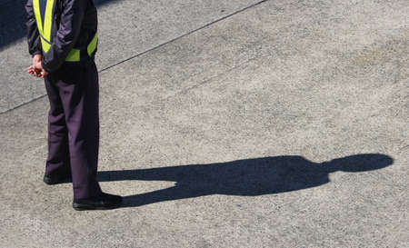backside of a standing construction site control Worker at airport runway ground.のeditorial素材