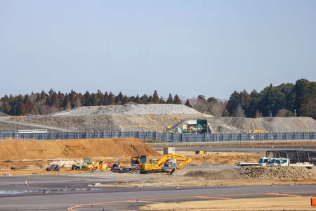 2020 March 04. Chiba JAPAN. Tractor, backhole and truck car working for developing new area of construction site work at Narita international Airport.のeditorial素材