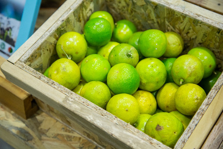 Green Lemon fresh in Wooden box, Thailand Market.