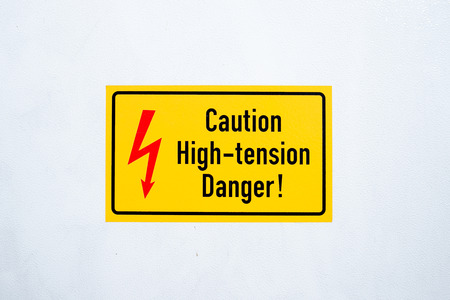 Danger High Voltage Sign for risk on yellow background.の写真素材