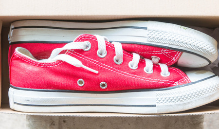 a pair of dirty sneakers isolated on whiteの写真素材