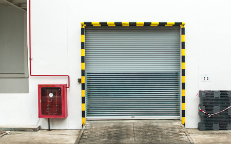 Building made of concrete with roller shutter doorの写真素材