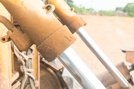Excavator working with earth and sand in sandpit in highway construction siteの写真素材