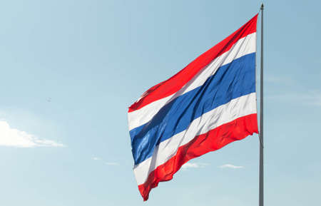 Image of waving Thai flag of Thailand with blue sky background.の写真素材