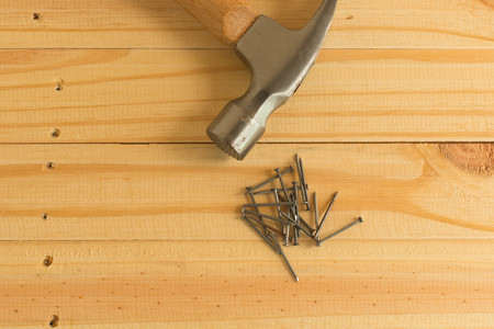 Hammer and nails on woodの写真素材
