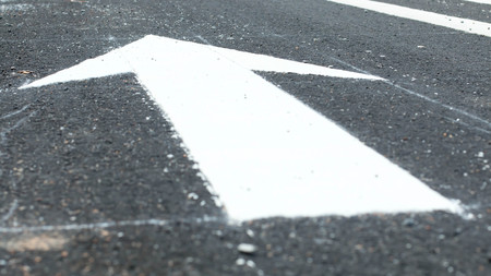 Road lanes with arrow markings at sunset