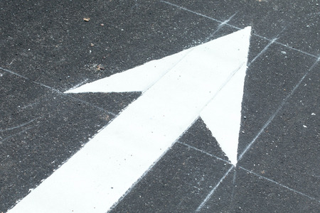 Road lanes with arrow markings at sunsetの写真素材