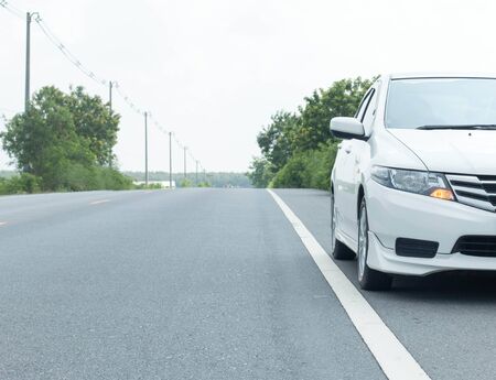 Close up front of new car parking on the asphalt roadの写真素材