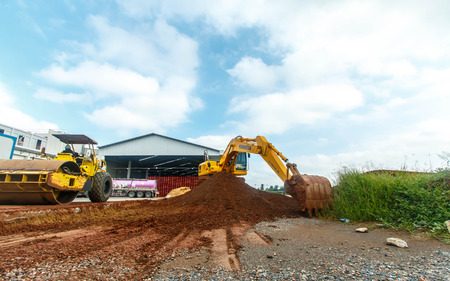 Excavator and grader working at construction site