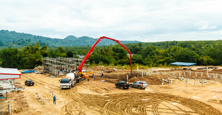 construction building works with concrete pumpの写真素材