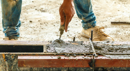 concreting work: construction site worker during concreteの写真素材