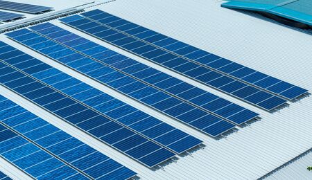 Architectural detail of metal roofing on commercial construction Solar panels or Solar cells on factory rooftop or terrace with sun light, Industry.の写真素材