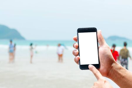 Hand using smartphone mobile in the vertical position, background blur