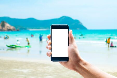 Hand using smartphone mobile in the vertical position, background blur