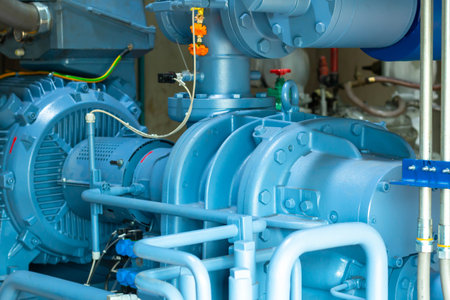 Industrial equipment, blue pumps and motors in a power plant.の写真素材