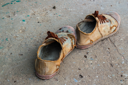 Old Brown sneakers on a concrete background.の写真素材