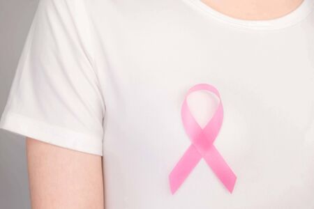 World Breast Cancer Day Concept,health care - woman wore pink t-shirt,Pink ribbon for breast cancer awareness, symbolic bow color raising awareness on people living with women's breast tumor illnessの写真素材
