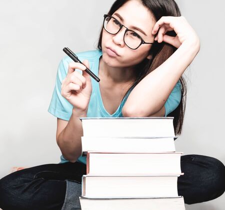 Beautiful asian female students during the exam Stay home and stressful and lazy reading books