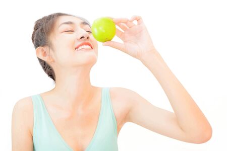 Young beautiful asian woman wore yellow undershirt, Holding a salad glass cup isolated on white background dummbellの写真素材
