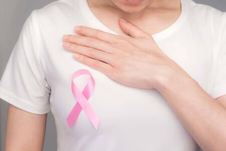 World Breast Cancer Day Concept,health care - woman wore pink t-shirt,Pink ribbon for breast cancer awareness, symbolic bow color raising awareness on people living with women's breast tumor illnessの写真素材
