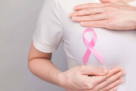 World Breast Cancer Day Concept,health care - woman wore pink t-shirt,Pink ribbon for breast cancer awareness, symbolic bow color raising awareness on people living with women's breast tumor illnessの写真素材